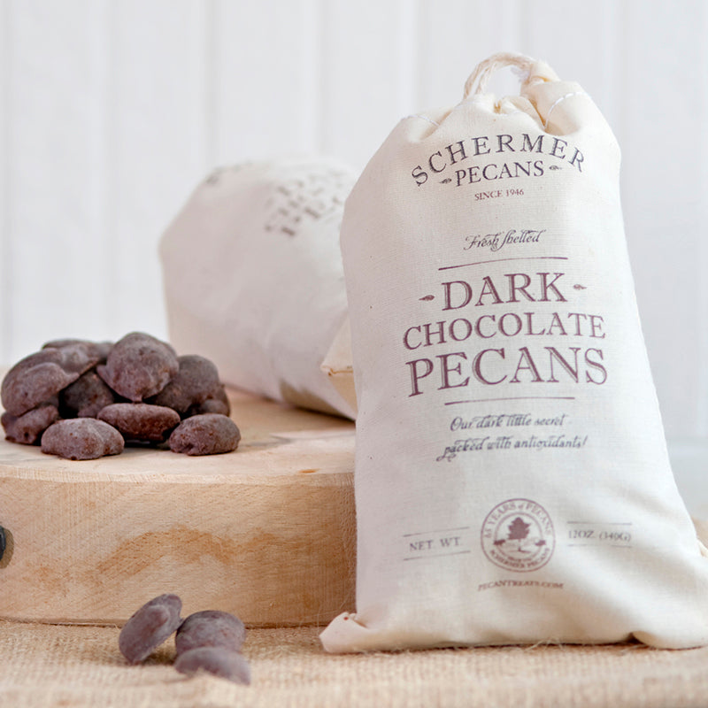 Photo of dark chocolate pecans in our cloth gift bag. 